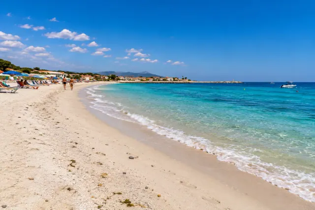 Santa Lucia, Siniscola — spiaggia chiara del borgo marinaro con acqua limpida e case sul lungomare