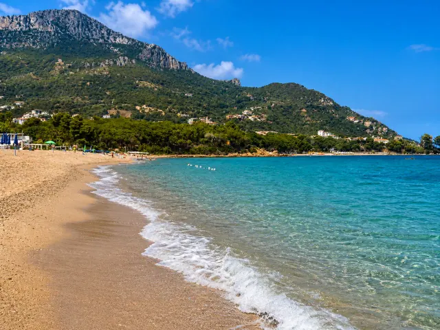 Santa Maria Navarrese, Baunei — spiaggia del paese con sabbia dorata, pineta e monte Oro sullo sfondo